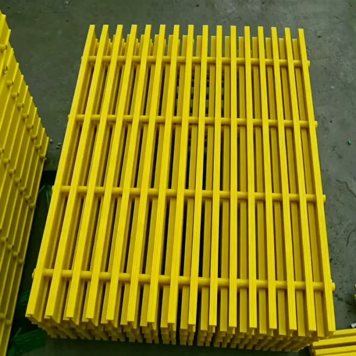FRP fiberglass grating panel close-up showing anti-slip grit surface
